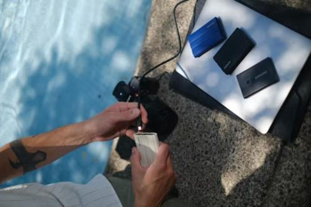 A person charging a device with portable power banks