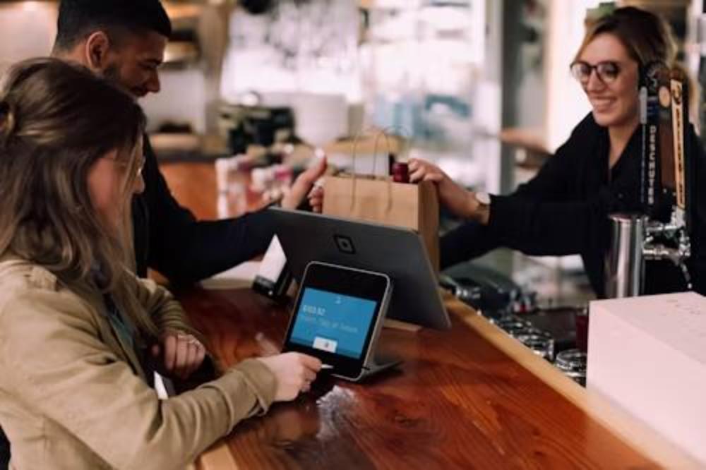 Customer paying at the checkout counter