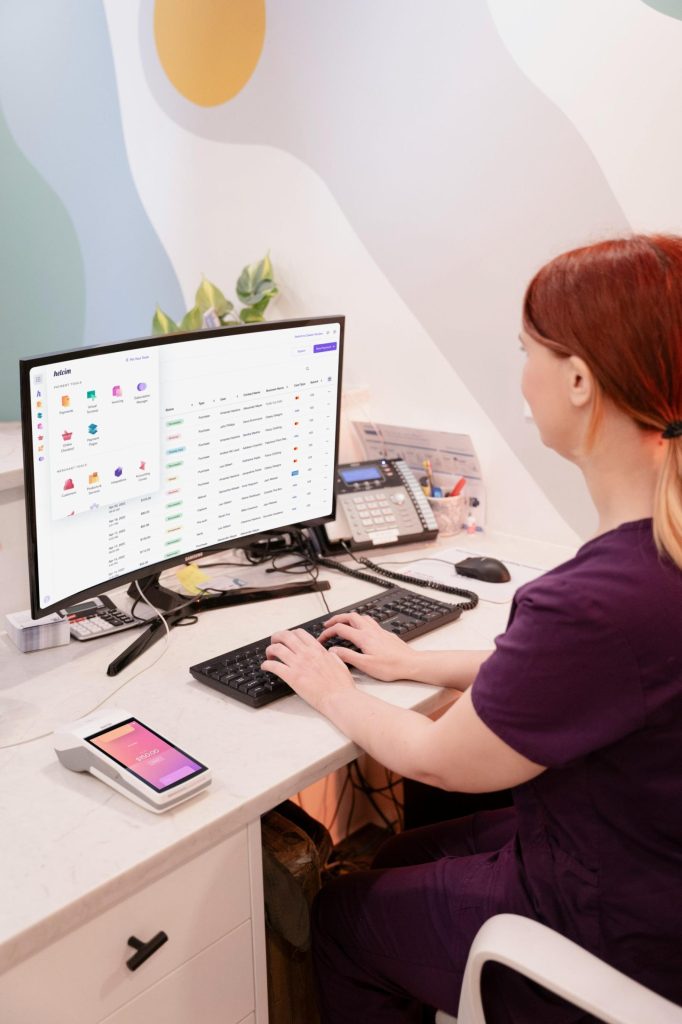 A receptionist working on a desktop computer