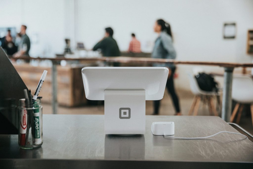 A modern point-of-sale system on a counter in a minimalist environment