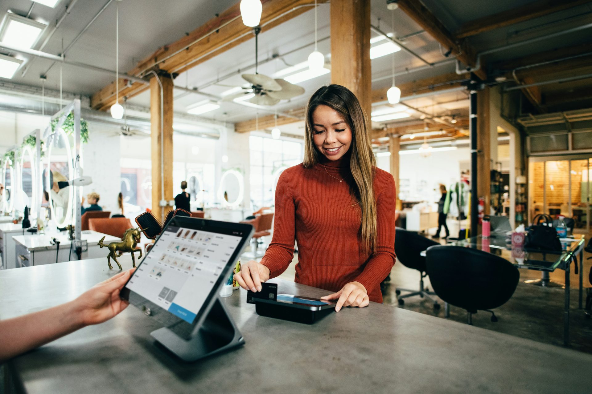 A woman making a payment at a point-of-sale system