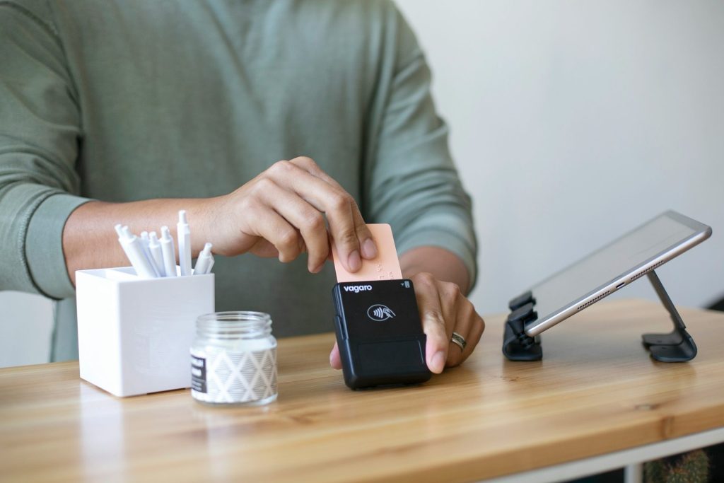 A person swiping a card on a terminal