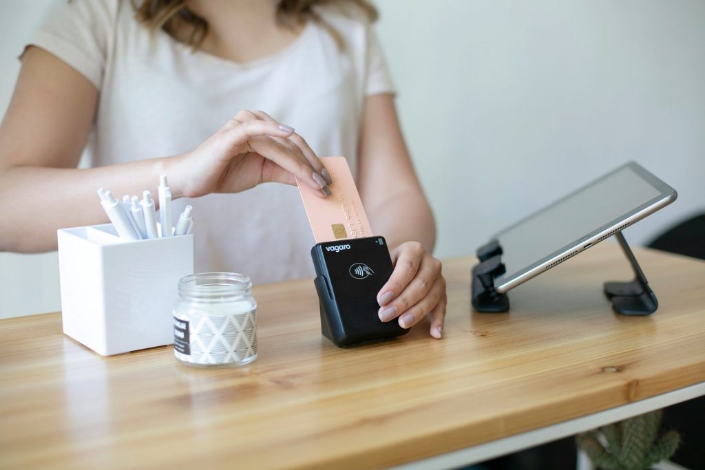 A person inserting a card into a portable card reader